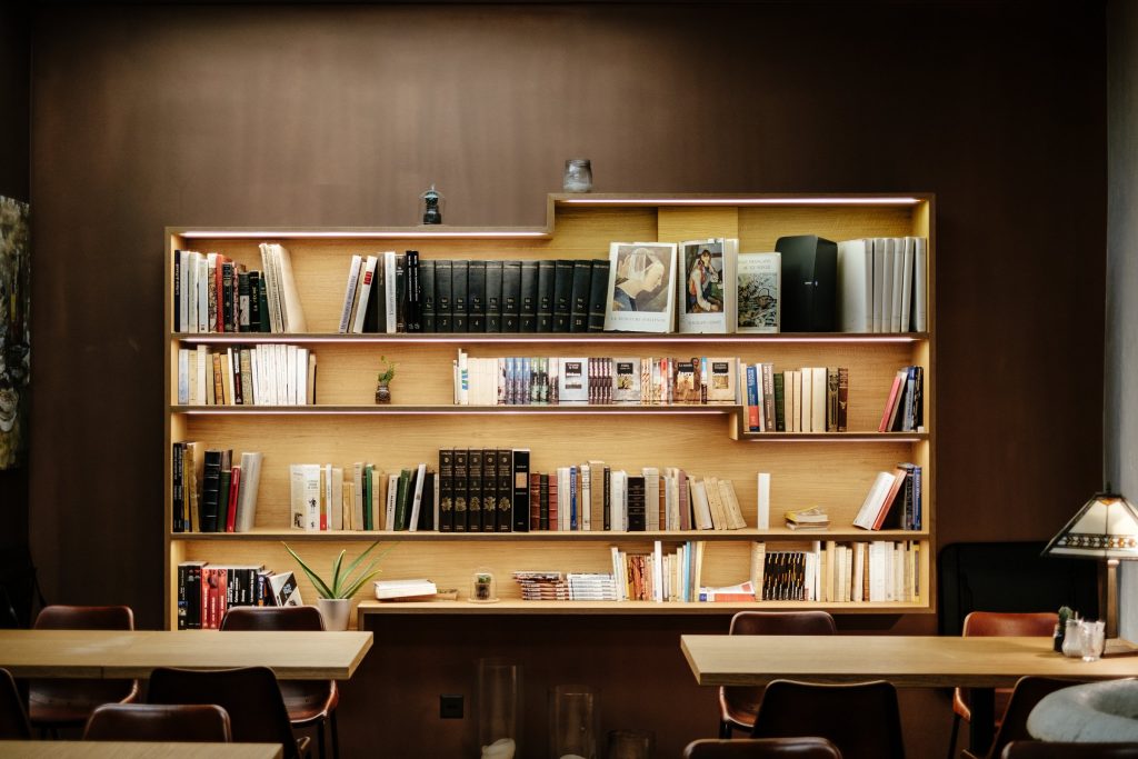 A quiet room lined with bookshelves and a long table