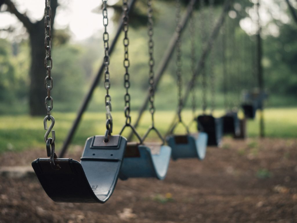 A row of empty swings in a park